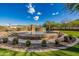 Captivating pool area with a waterfall and desert landscaping set against a stunning mountain backdrop at 1607 W Pearce Rd, Phoenix, AZ 85041