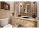 Elegant powder room showcasing a marble countertop, decorative mirror, and stylish lighting at 1607 W Pearce Rd, Phoenix, AZ 85041