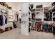 This large walk-in closet offers ample storage and organization with custom shelving and hanging racks at 1607 W Pearce Rd, Phoenix, AZ 85041