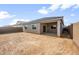 View of home's backyard with covered patio and block wall fence at 17761 W Getty Dr, Goodyear, AZ 85338