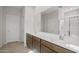 Bathroom featuring a double vanity with white countertops, and a framed mirror at 17761 W Getty Dr, Goodyear, AZ 85338