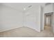 Bright bedroom with neutral carpet, a closet with sliding doors, and white walls at 17761 W Getty Dr, Goodyear, AZ 85338