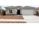 Charming single-story home with a two-car garage, neutral paint, and low-maintenance landscaping at 17761 W Getty Dr, Goodyear, AZ 85338