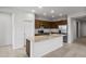 Well-lit kitchen featuring stainless steel appliances, granite countertops, and a large island with a sink at 17761 W Getty Dr, Goodyear, AZ 85338