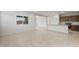 Open-concept living space featuring tile floors seamlessly connecting living area and kitchen at 17761 W Getty Dr, Goodyear, AZ 85338