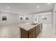 Open-concept living area with tile flooring, recessed lighting, and a kitchen island at 17761 W Getty Dr, Goodyear, AZ 85338