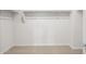 Empty walk-in closet featuring carpeted flooring and white shelving and trim at 17761 W Getty Dr, Goodyear, AZ 85338