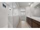 Bathroom showing a tiled shower and a dual sink vanity, exuding modern style at 17776 W Getty Dr, Goodyear, AZ 85338