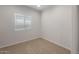 Bright bedroom featuring a window and comfortable neutral carpet at 17776 W Getty Dr, Goodyear, AZ 85338