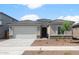 Charming single-story home featuring a two-car garage and desert landscaping at 17776 W Getty Dr, Goodyear, AZ 85338