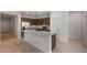 Well-appointed kitchen featuring a large island with sink, granite countertops, and stainless steel appliances, ideal for cooking and gathering at 17776 W Getty Dr, Goodyear, AZ 85338
