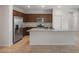 Modern kitchen boasts stainless steel appliances, granite countertops, and dark wood cabinetry, creating a sleek and functional cooking space at 17776 W Getty Dr, Goodyear, AZ 85338