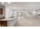 Bright and open living room with tile floors and a kitchen island at 17776 W Getty Dr, Goodyear, AZ 85338