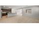 Bright open concept living space with kitchen, island, and tiled floors at 17776 W Getty Dr, Goodyear, AZ 85338