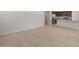 Spacious living room with tiled floors, seamlessly connecting to the modern kitchen area, perfect for entertaining and daily living at 17776 W Getty Dr, Goodyear, AZ 85338