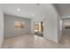 Bright living room with tile floors and a sliding glass door, offering easy access to outdoor spaces and ample natural light at 17776 W Getty Dr, Goodyear, AZ 85338