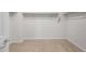 Spacious walk-in closet with carpeted floors and ample storage at 17776 W Getty Dr, Goodyear, AZ 85338