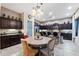 Elegant eat-in kitchen showcases modern appliances, a chandelier, and granite countertops at 1829 N Atwood --, Mesa, AZ 85207