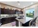 Stylish kitchen featuring dark wood cabinets, stainless steel appliances, and a center island at 1829 N Atwood --, Mesa, AZ 85207