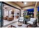 This covered patio offers a seamless indoor-outdoor living experience with comfortable seating and views of the home's interior at 1829 N Atwood --, Mesa, AZ 85207