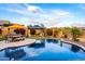 Beautiful outdoor space with pool, lush landscaping, pergola, and dining area is perfect for entertaining and relaxation at 1829 N Atwood --, Mesa, AZ 85207