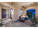 Charming outdoor porch featuring stone floors, comfortable seating, and a cozy fire pit at 1829 N Atwood --, Mesa, AZ 85207