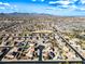 A wide aerial shot displays a peaceful residential community with mature landscaping, and a clear blue sky at 1849 S 225Th Dr, Buckeye, AZ 85326