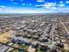This aerial perspective reveals a tidy residential neighborhood with lush backyard pools and solar panels gleaming in the sunlight at 1849 S 225Th Dr, Buckeye, AZ 85326