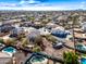 An aerial capture offers a neighborhood perspective highlighting backyard pools, well-kept homes, and mature trees on a sunny day at 1849 S 225Th Dr, Buckeye, AZ 85326