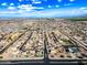 Expansive aerial view showcasing a well-planned residential community under a bright, partly cloudy sky and mountain backdrop at 1849 S 225Th Dr, Buckeye, AZ 85326