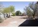 Spacious backyard with mature trees, a shed, and an open area perfect for landscaping or recreation at 1849 S 225Th Dr, Buckeye, AZ 85326