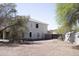 Expansive backyard with mature trees, storage shed, and plenty of space for outdoor activities, set against a clear blue sky at 1849 S 225Th Dr, Buckeye, AZ 85326