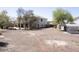 Extensive backyard with mature trees, basketball hoop, storage shed, covered structure, and plenty of open space at 1849 S 225Th Dr, Buckeye, AZ 85326