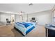 A spacious bedroom with carpeted floors, featuring a ceiling fan and a view into an adjacent bathroom at 1849 S 225Th Dr, Buckeye, AZ 85326