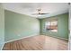 Airy bedroom featuring light wood flooring and a modern ceiling fan at 1849 S 225Th Dr, Buckeye, AZ 85326