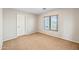 Empty bedroom featuring carpeted floors and a window at 1849 S 225Th Dr, Buckeye, AZ 85326