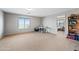 Spacious bonus room with carpet flooring and a large window for natural light at 1849 S 225Th Dr, Buckeye, AZ 85326