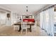 Inviting dining area with a wooden table, white chairs, and bright natural light at 1849 S 225Th Dr, Buckeye, AZ 85326