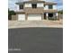 Inviting two-story home featuring a three-car garage and charming front porch at 1849 S 225Th Dr, Buckeye, AZ 85326