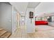 Well-lit hallway with access to a bathroom and a living area, featuring stylish tile flooring at 1849 S 225Th Dr, Buckeye, AZ 85326