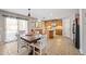 Eat-in kitchen with a view of the dining table, kitchen island, and natural light at 1849 S 225Th Dr, Buckeye, AZ 85326