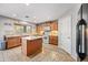 Traditional style kitchen featuring an island, light oak cabinets, and stainless steel appliances at 1849 S 225Th Dr, Buckeye, AZ 85326