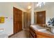 Bathroom with a tile shower, cabinet, mirror, and fixtures at 1905 N Calle Maderas --, Mesa, AZ 85213