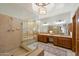 Bright bathroom with tile shower, sunken tub, double vanity, and decorative window at 1905 N Calle Maderas --, Mesa, AZ 85213