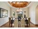 Chic dining room featuring a dark table, upholstered chairs, and a decorative ceiling at 1905 N Calle Maderas --, Mesa, AZ 85213