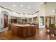 Large kitchen island with wood cabinetry, tile countertops, and a view of the backyard pool at 1905 N Calle Maderas --, Mesa, AZ 85213