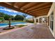 Covered patio overlooks a sparkling pool and fountain in the backyard at 1905 N Calle Maderas --, Mesa, AZ 85213