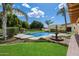 Beautiful pool and fountain surrounded by a lush lawn with mature landscaping at 1905 N Calle Maderas --, Mesa, AZ 85213
