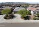 Aerial view of a single-story home with desert landscaping in a quiet neighborhood with mountain views at 19984 W Washington St, Buckeye, AZ 85326