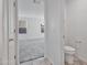 Bright bedroom boasts neutral carpet, two windows, and ensuite bathroom providing comfort and style at 19984 W Washington St, Buckeye, AZ 85326